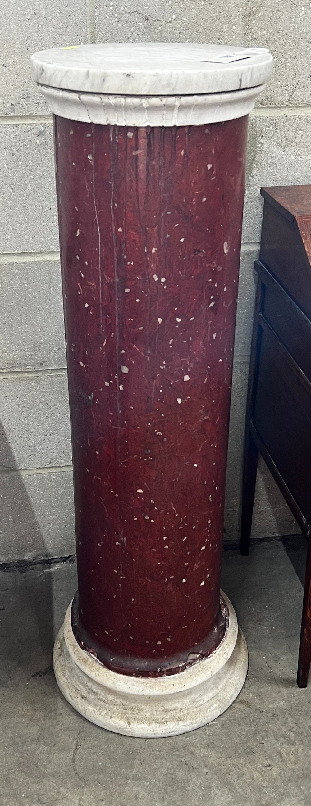 A faux porphyry column with circular marble top, height 104cm